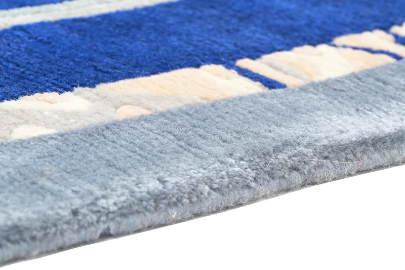 Handgeknüpfter Tibeter Teppich in blau mit Retro-Bordüre – Neuwertig